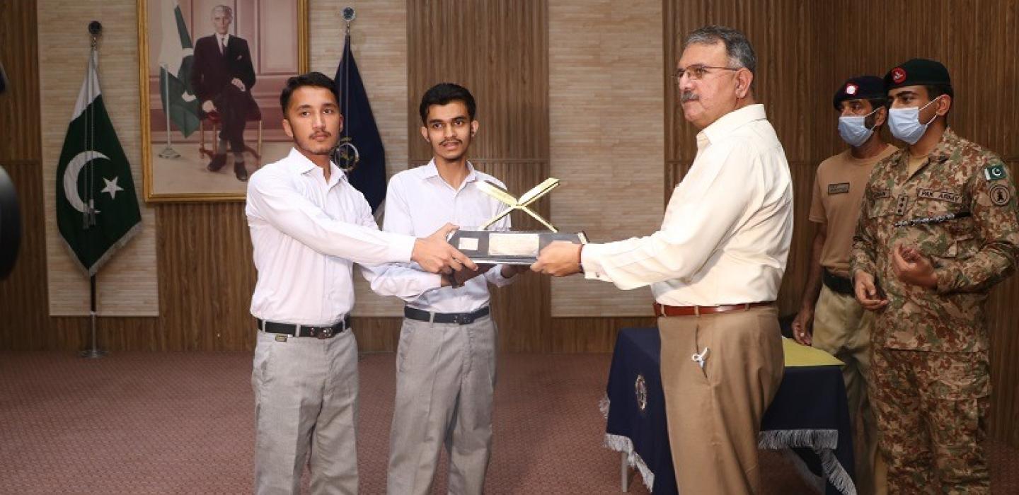 Principal is awarding trophy to the students